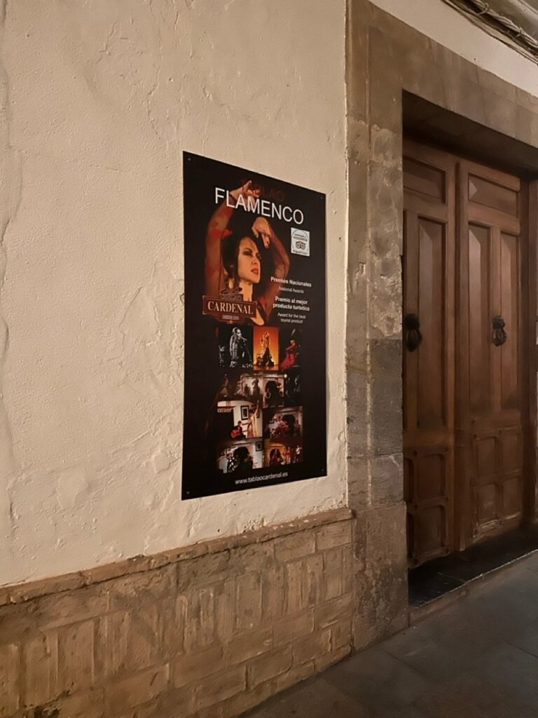 Flamenco poster on a wall beside a wooden door in the old town