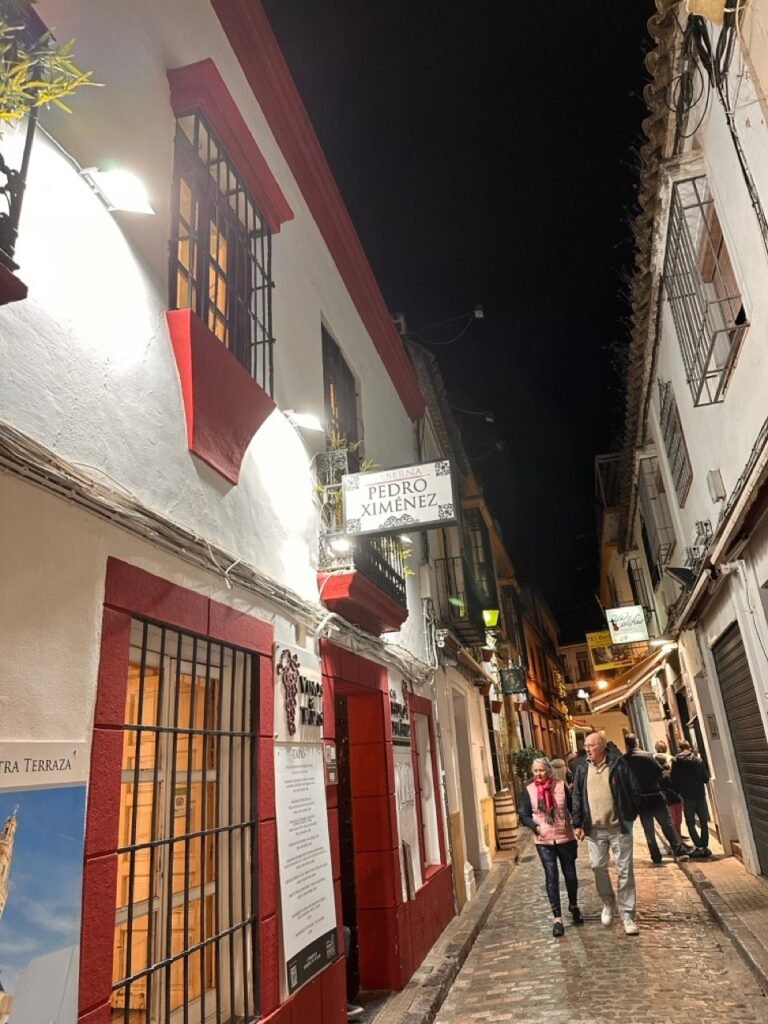 Narrow old town street at night with red-trimmed whitewashed buildings