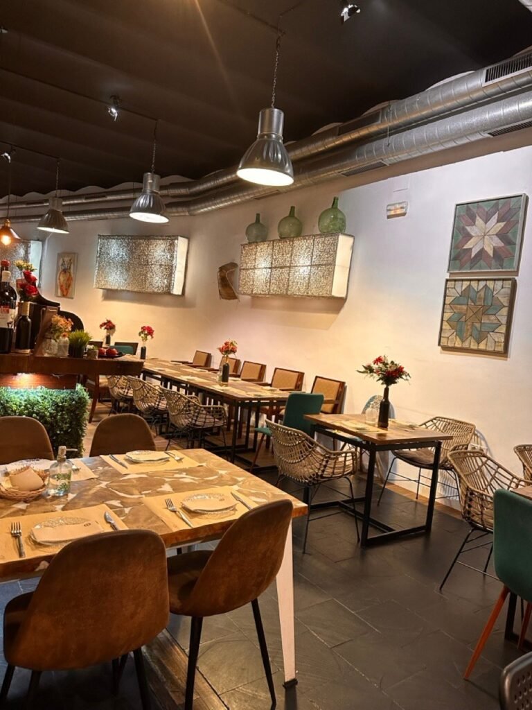 Restaurant dining room with wooden tables and decorative tiles on the wall
