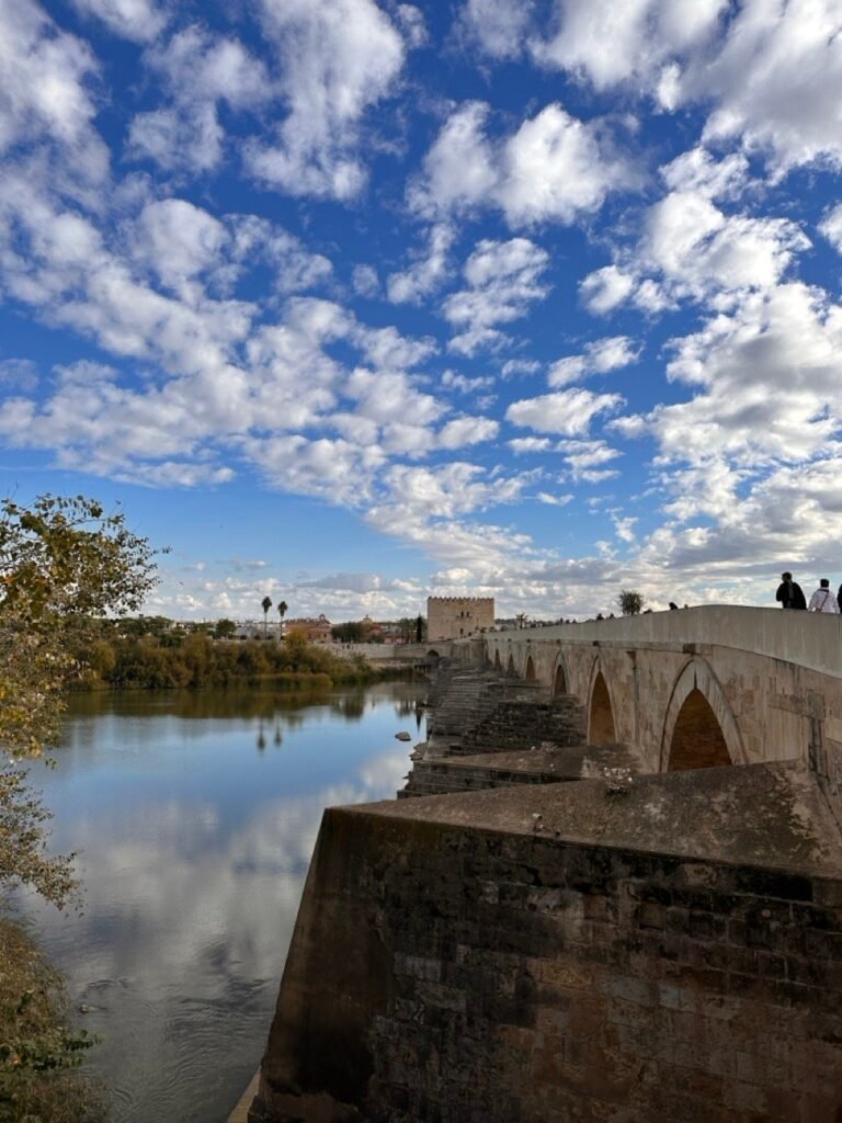 The Roman Bridge and river under a sky of scattered clouds