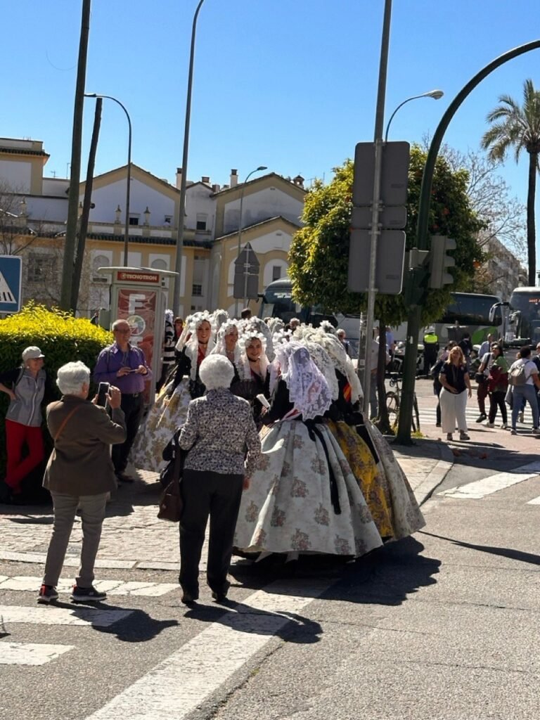 People in traditional dress walking along a Córdoba street