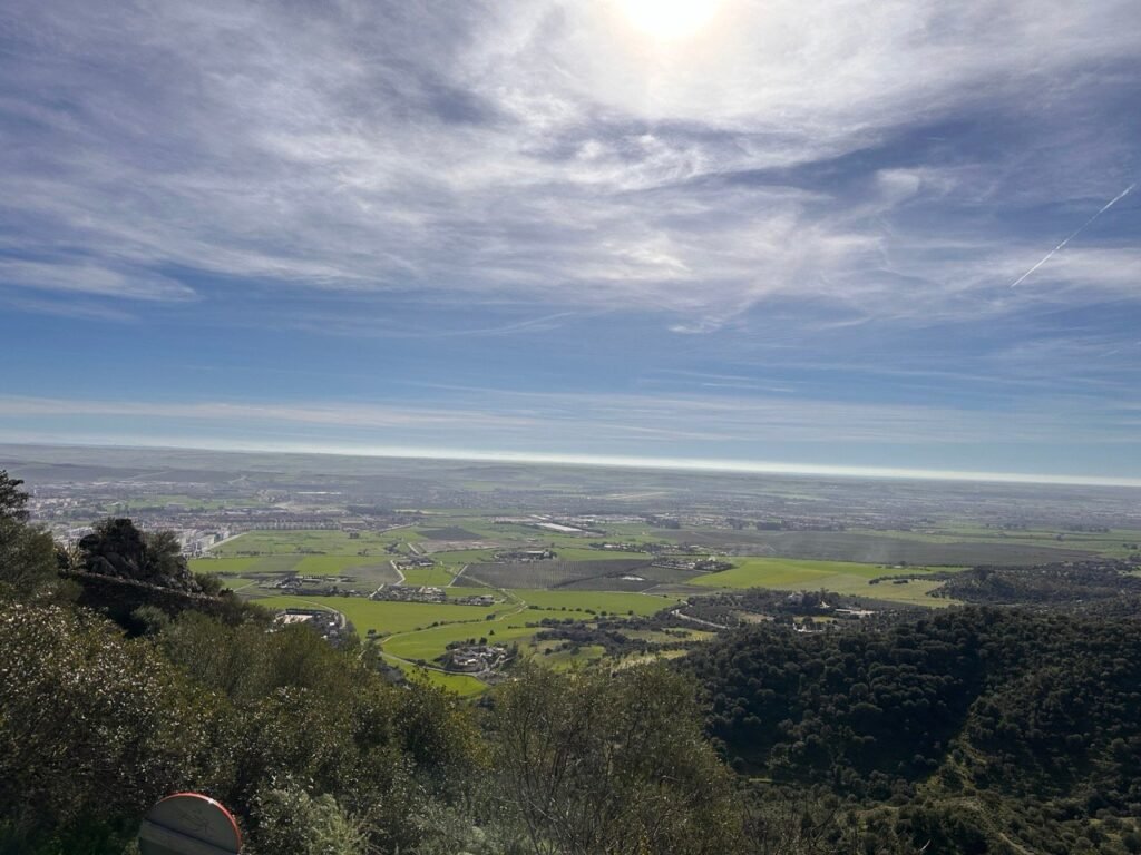 View over green farmland and the horizon from the hills near Córdoba